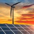 Concept clean energy. wind turbine and solar panel in sunris Royalty Free Stock Photo