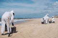 Concept: Cleaning the coast. Group of unrecognizable people. Cleaning the beach after a fuel spill. Natural Park Royalty Free Stock Photo