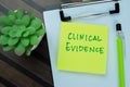 Concept of Clinical Evidence write on sticky notes isolated on Wooden Table