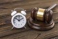 The concept of a clock and a hammer by the judge. Royalty Free Stock Photo