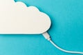 The concept of cloud technologies, cloud storage. A white cable is connected to a cloud on a blue background Royalty Free Stock Photo