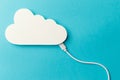 The concept of cloud technologies, cloud storage. A white cable is connected to a cloud on a blue background. Top view Royalty Free Stock Photo