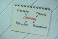 Concept of Coaching write on a book with keyword isolated on Wooden Table