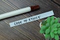 Concept of Code of Ethics write on sticky notes isolated on Wooden Table Royalty Free Stock Photo