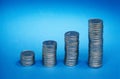 coins showing growth graph on blue background Royalty Free Stock Photo