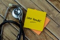 Concept of Cold Hands write on sticky notes with stethoscope isolated on Wooden Table