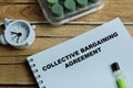 Concept of collective bargaining agreement write on book isolated on Wooden Table Royalty Free Stock Photo