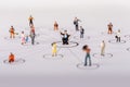 The concept of a collective solution to any problem. Miniature toy workers. Royalty Free Stock Photo