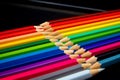 Concept-colored pencils laid out on a dark background