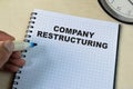 Concept of Company Restructuring write on book  on Wooden Table Royalty Free Stock Photo