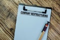 Concept of Company Restructuring write on paperwork isolated on Wooden Table Royalty Free Stock Photo