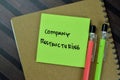 Concept of Company Restructuring write on sticky notes isolated on Wooden Table Royalty Free Stock Photo