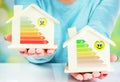 Concept comparison between normal house and low consumption house with energy efficiency rating Royalty Free Stock Photo