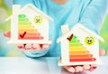 Concept comparison between normal house and low consumption house with energy efficiency rating Royalty Free Stock Photo
