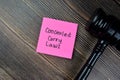 Concept of Concealed Caryy Laws write on sticky notes with gavel isolated on Wooden Table Royalty Free Stock Photo