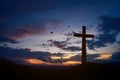 Concept conceptual black cross religion symbol silhouette in grass over sunset Royalty Free Stock Photo