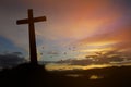 Concept conceptual black cross religion symbol silhouette in grass over sunset Royalty Free Stock Photo