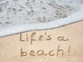 Concept or conceptual hand made or handwritten text in sand on a beach in an exotic island for summe Royalty Free Stock Photo
