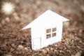 The concept or conceptual house white paper in his hand in a green summer grass on a background, a symbol for the construction, Royalty Free Stock Photo