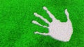 Ornamental gravel handprint on grass background