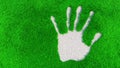 Ornamental gravel handprint on grass background