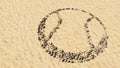 Stones on beach sand handmade symbol shape, golden sandy background, ball sign