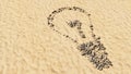 Stones on beach sand handmade symbol shape, golden sandy background, lightbulb sign