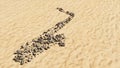 Stones on beach sand handmade symbol shape, golden sandy background, saxophone sign