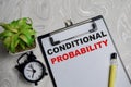 Concept of conditional probability write on clipboard isolated on Wooden Table Royalty Free Stock Photo