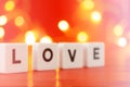 The concept of confession of love. Inscription love on a beautiful yellow bokeh background.