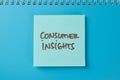 Concept of Consumer Insights write on sticky notes isolated on Wooden Table Royalty Free Stock Photo