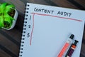 Concept of Content Audit write on book, Supported by an additional services isolated on Wooden Table Royalty Free Stock Photo