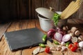 The concept of cooking.Fresh raw vegetables and spices for soup, a pot of pasta, on a rustic wooden table . Health food Royalty Free Stock Photo