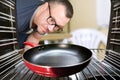 Concept of cooking by men, looking at oven for preparing food. Men cooking at home. View from inside Royalty Free Stock Photo