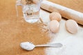 Concept of cooking pasta. Chicken eggs, water, flour and a rocking chair on the table.