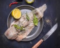 Concept cooking raw cod with herbs and lemon in a frying pan wooden rustic background top view close up Royalty Free Stock Photo