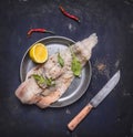 Concept cooking raw cod with herbs and lemon in a frying pan wooden rustic background top view close up Royalty Free Stock Photo