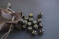 Close-up set of gaming dice rolled out of leather bag on dark background. Royalty Free Stock Photo