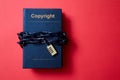 Concept for copyright, patent or intellectual property and idea protection. Book wrapped in a chain with a lock.