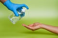 Wallpaper. Still life of hand with surgical glove. Applying antiviral alcohol on a female hand