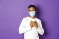 Concept of coronavirus, quarantine and lifestyle. Image of handsome african-american man in medical mask, saying thank