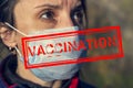 Concept of coronavirus vaccination, woman tired of wearing a mask, wants to breathe freely, selective focus on mask, stamp