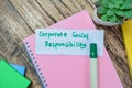 Concept of Corporate Social Responsibility write on sticky notes isolated on Wooden Table Royalty Free Stock Photo