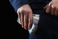 Concept for corruption, bankruptcy, bail, crime, bribing, fraud. Bundle of dollar cash in hand Royalty Free Stock Photo