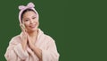 Concept of cosmetics, skincare, self-care, and rejuvenation. Asian woman wearing pink bathrobe and holding scrub, set