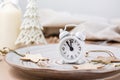 Concept Countdown on Christmas night. Table setting. Alarm clock five to twelve on a plate and christmas eco decorations on the Royalty Free Stock Photo