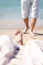 The concept of a couple on vacation, women& x27;s feet and men& x27;s feet on the beach by the sea. Royalty Free Stock Photo