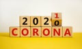 Concept of covid-19 pandemic in 2021. Fliped a wooden cube and changed the words `corona 2020` to `corona 2021`. Beautiful yel Royalty Free Stock Photo