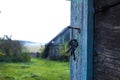 The concept of a cozy father\'s home: a bunch of old keys on a rusty nail against the backdrop of an old garden Royalty Free Stock Photo