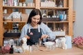Concept craftswoman small business. Young woman workplace is engaged in production of aromatic wax candles in shape of Royalty Free Stock Photo